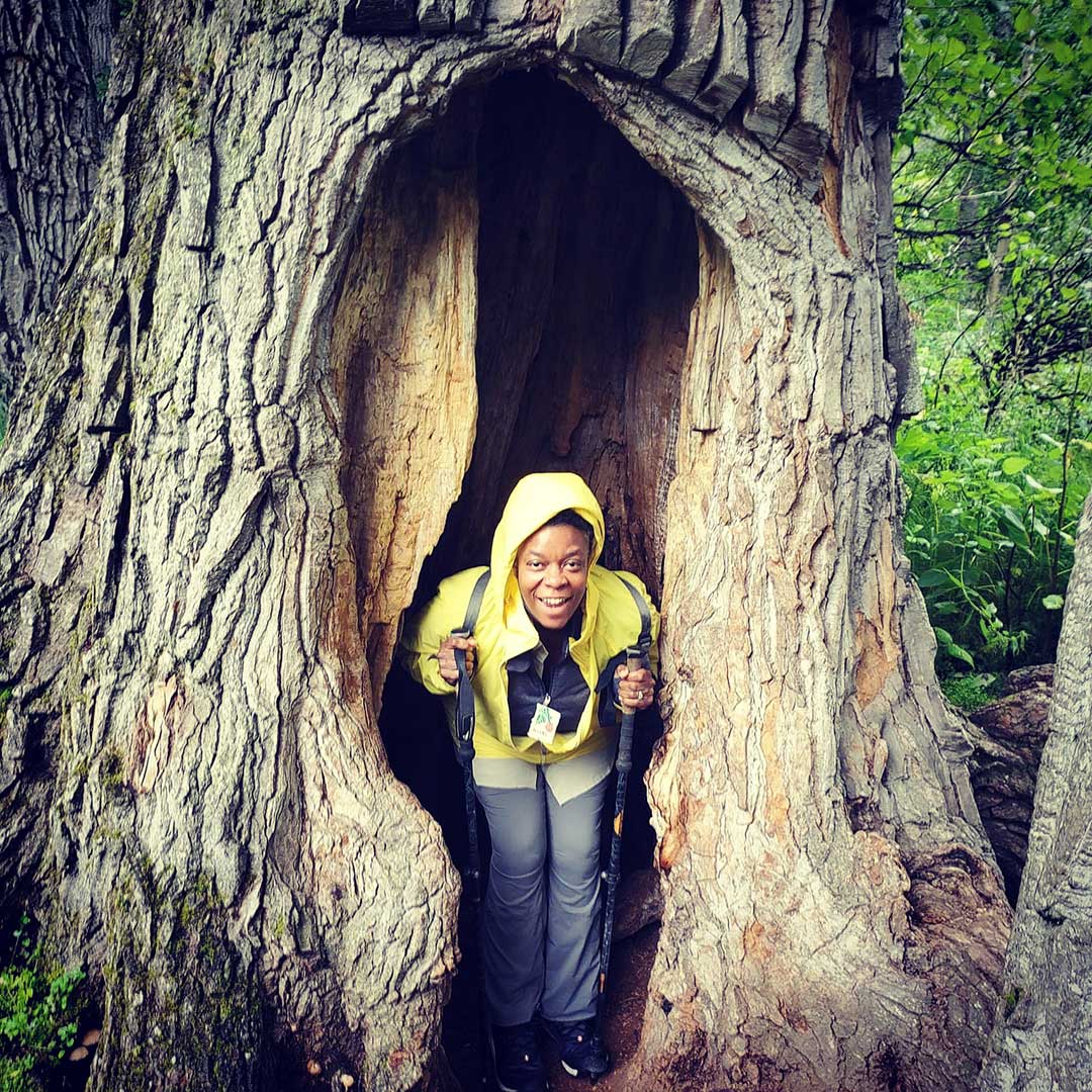 Kishi Ducre standing inside a huge tree